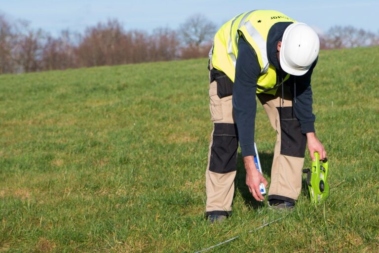 Ground survey for construction site hoardings being carried out
