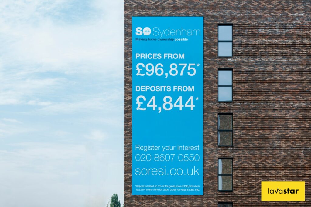 Tensioned banner system fixed to brick wall