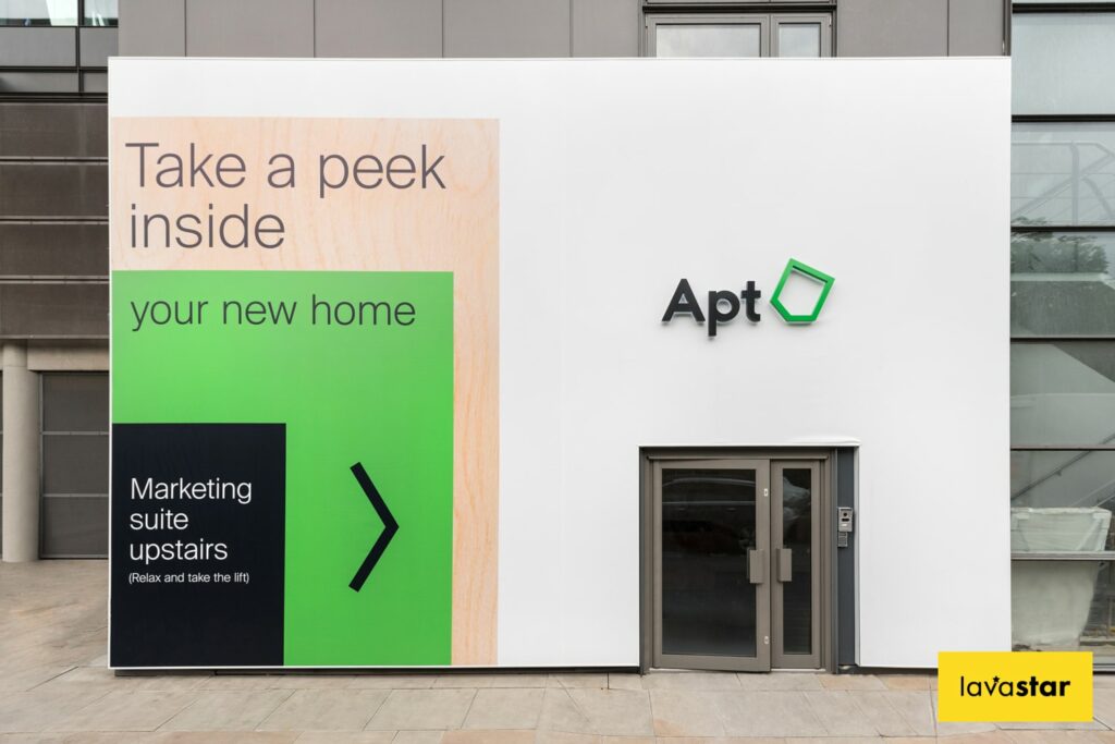 Printed building facade wrap using PVC stretched into a tensioned aluminium track