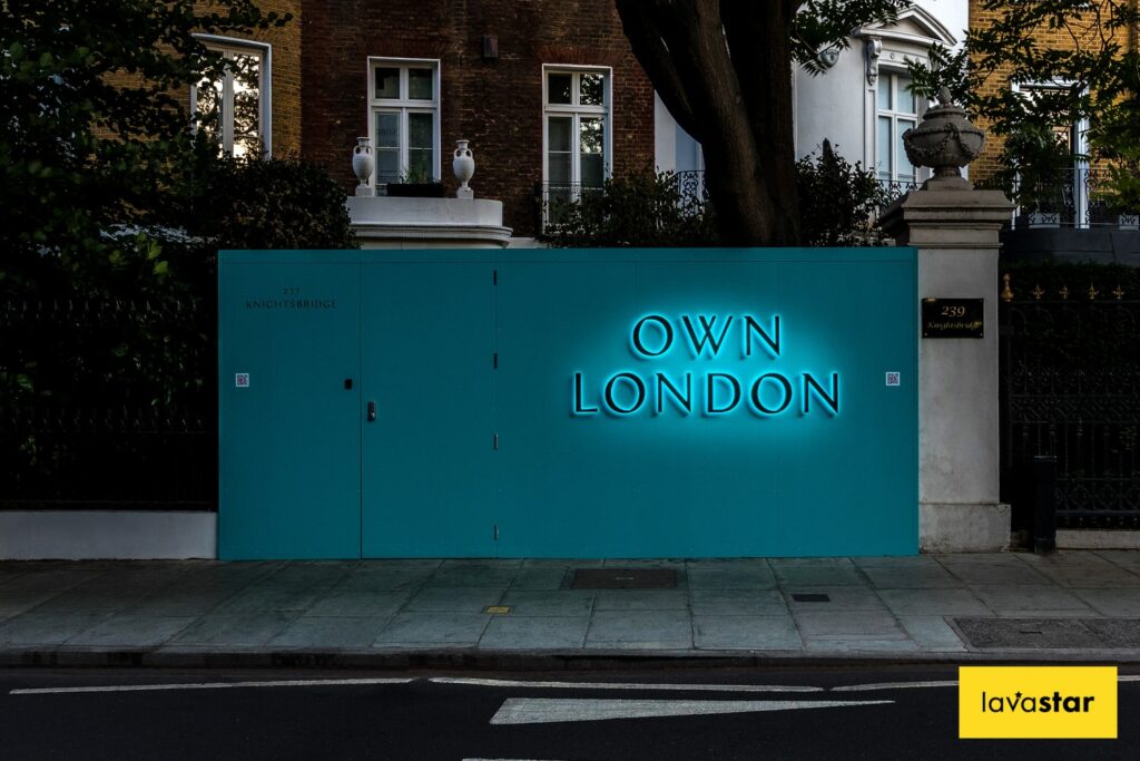 Illuminated site hoarding at night