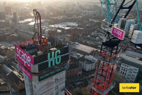 Aerial view of a city construction site with cranes and high rise building under construction