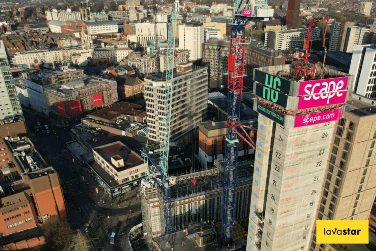 Aerial view of city construction site with cranes and high-rise building