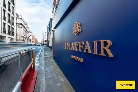 Construction hoarding signage installed in London featuring bespoke rear illuminated logo