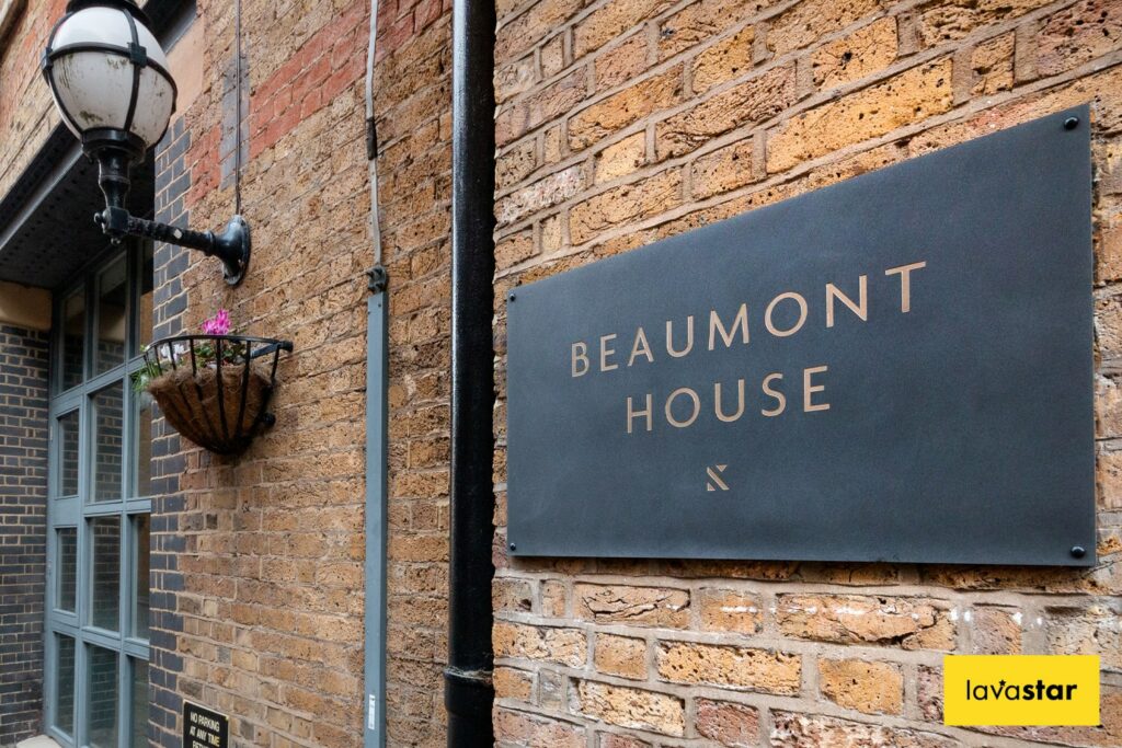 Etched slate navigational plaque for tenant signage at an office