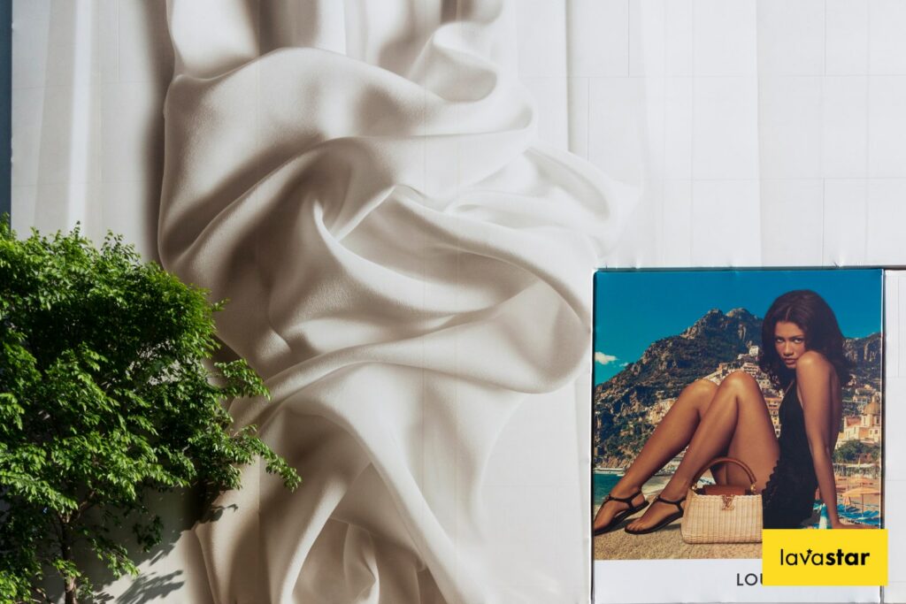 Building wrap advertising window on large development in central London