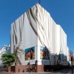 A printed building wrap installed off a scaffolding with key clamp sub frame