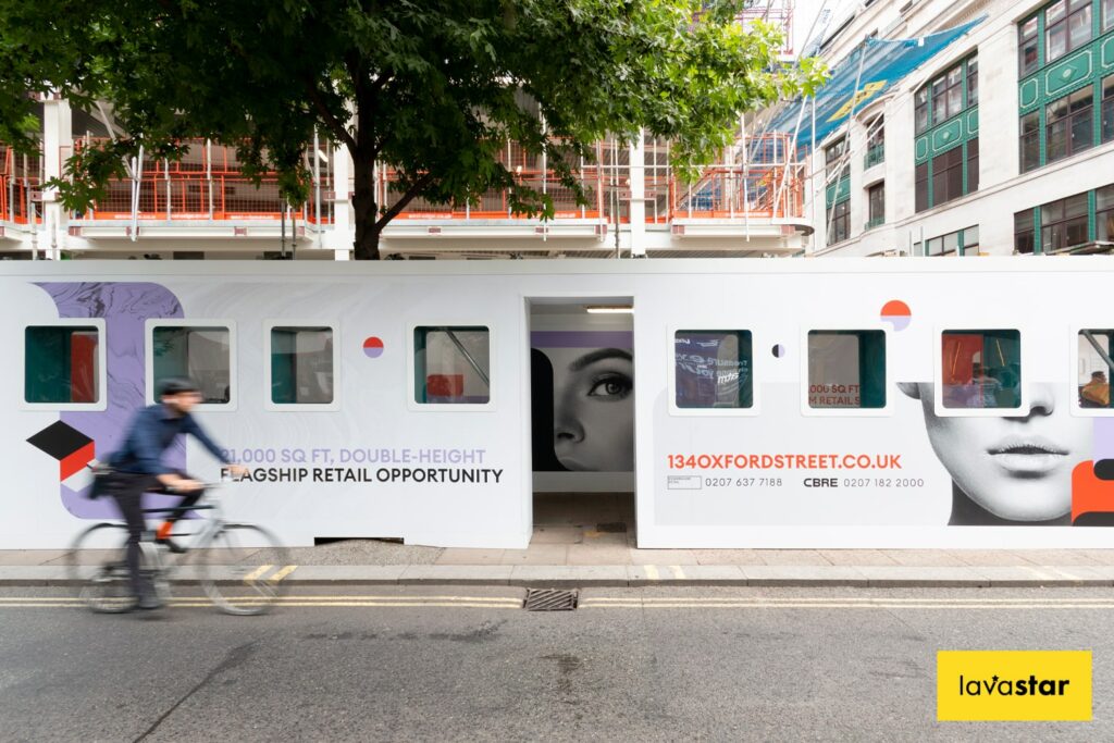 Creative construction hoarding for a gantry on a construction site featuring acrylic viewing windows