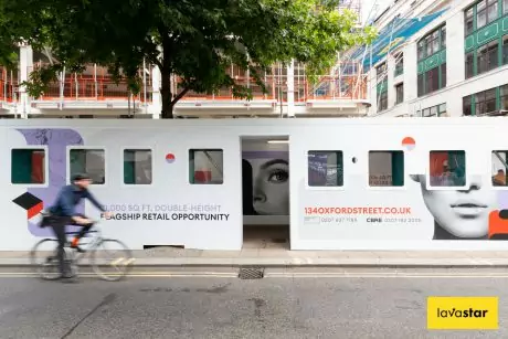 Creative construction hoarding for a gantry on a construction site featuring acrylic viewing windows