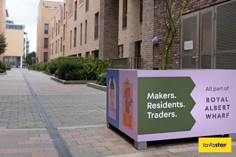 Printed wrap installed over a planter within a new housing development