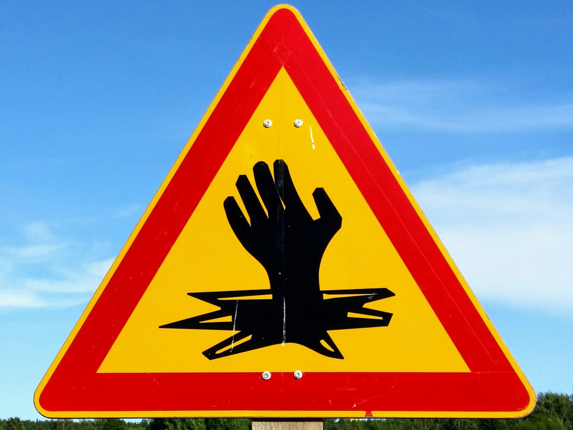 a safety sign with red, yellow, and black colours