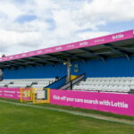 Printed dibond boards installed on a football stadium stand to advertise a sponsor
