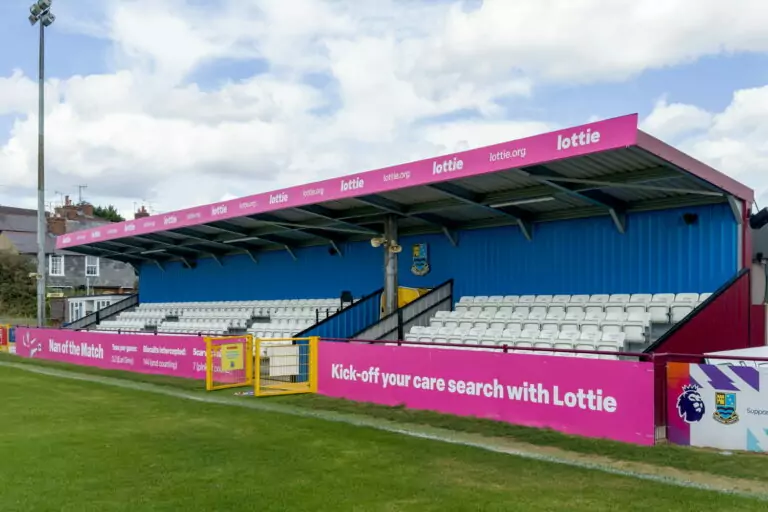 Printed dibond boards installed on a football stadium stand to advertise a sponsor
