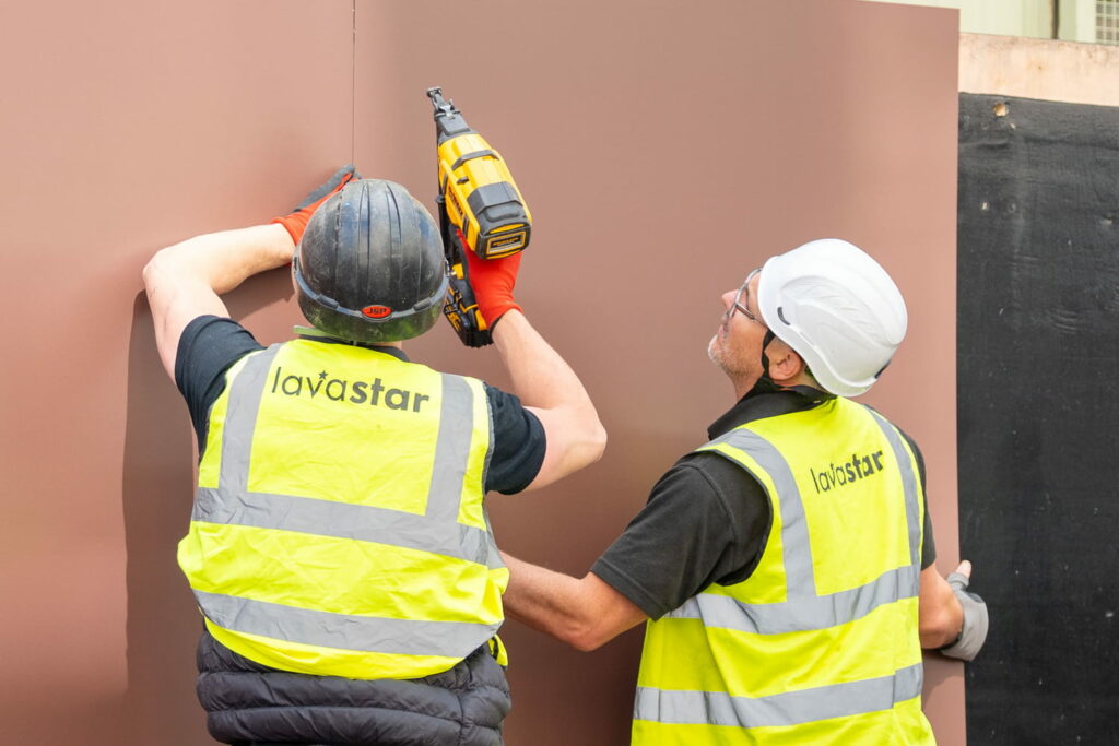 Printed hoarding boarding installation taking place by professional install crew